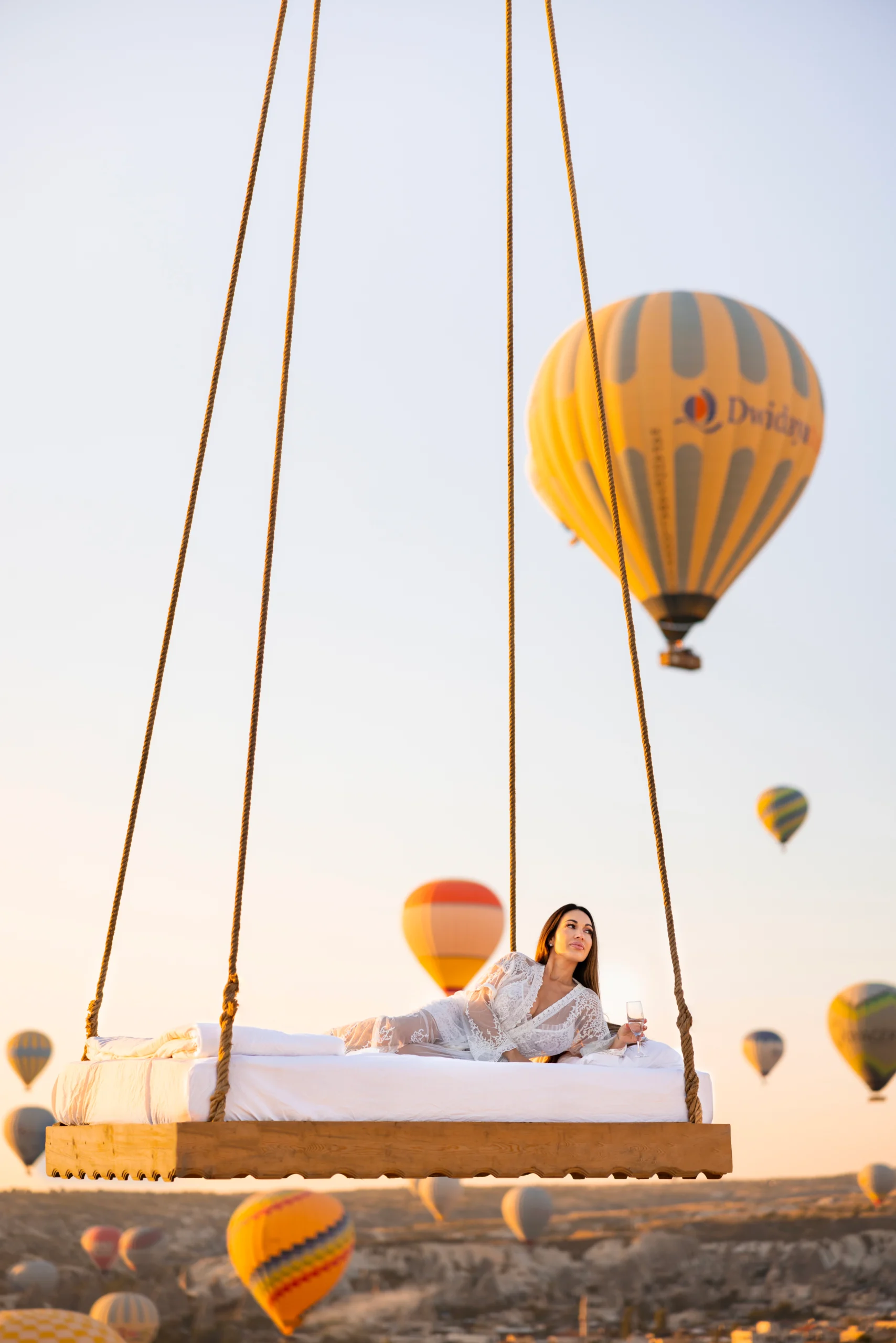 Cappadocia Bed Photoshoot: Floating Bed Experience in Fairy Landscapes 4 Cappadocia bed photoshoot with swing bed and balloons